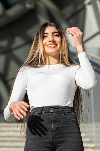 Vertical photo of young lady smiling on the stairs High quality photo