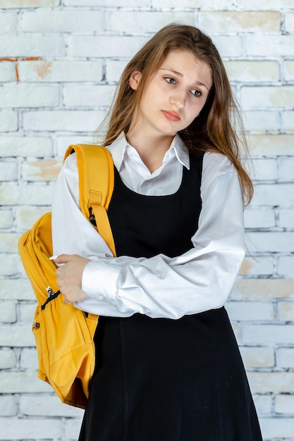 Free photo vertical photo of young student crossed her arms and thinking high quality photo