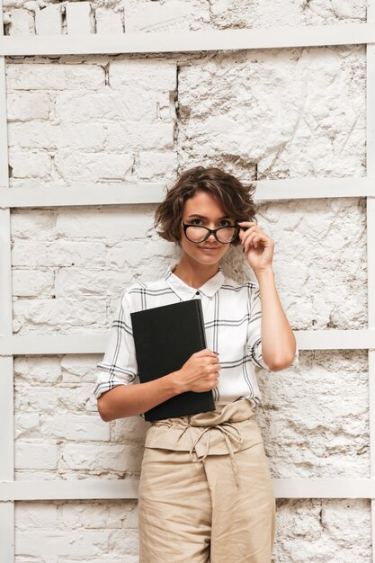 Vertical picture of Pensive curly female manager