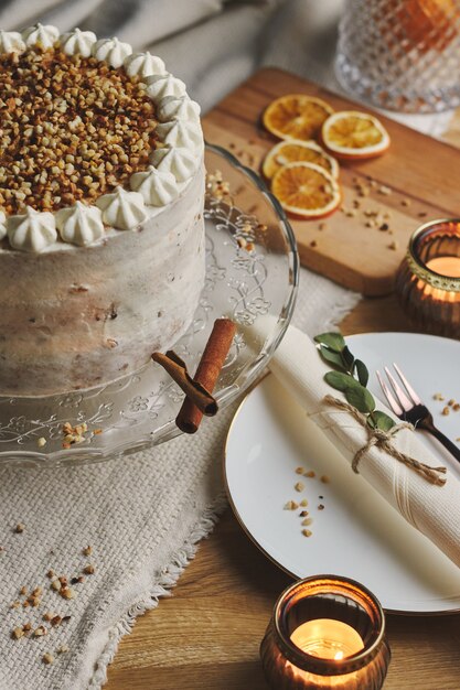 Vertical picture of a white delicious Christmas cake with nuts and mandarine