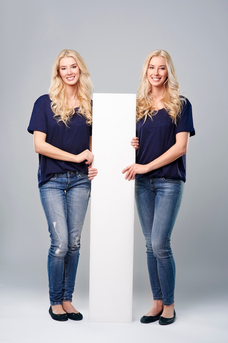 Free Photo vertical placard between cheerful twins

