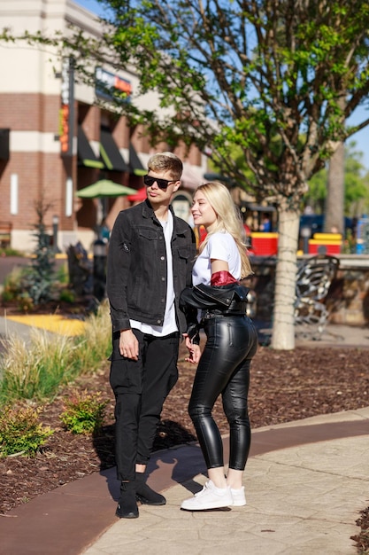 Vertical portrait of adorable couple standing on at the park