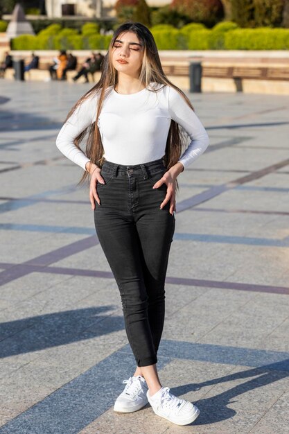 Vertical portrait of calm beautiful girl standing on at the street High quality photo