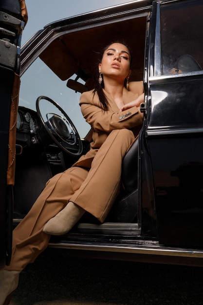 Vertical portrait of confident girl sittin on driver seat and looking at the camera High quality photo