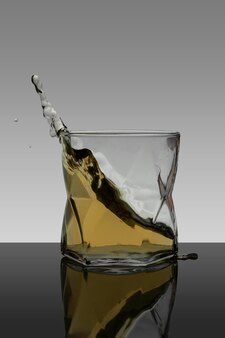 Vertical portrait splash of whiskey in crystal glass with gradient background
