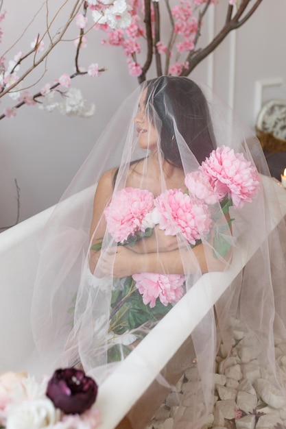 Vertical portrait of young girl holding colorful flowers and looking aside High quality photo