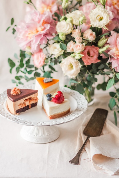 Vertical selective focus of a cake stand with tasty cake pieces