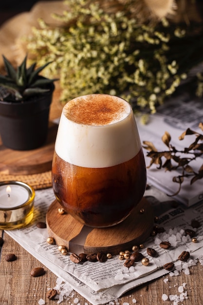 Vertical selective focus closeup of a glass of fresh coffee