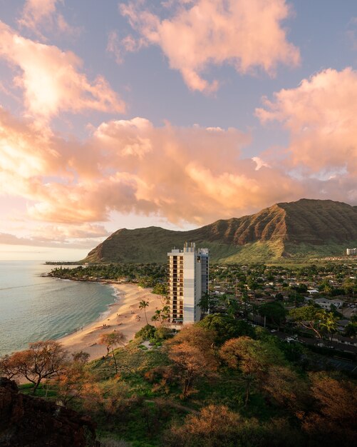 Vertical shot of an apartment on the beach shore under a beautiful sky - great for a background