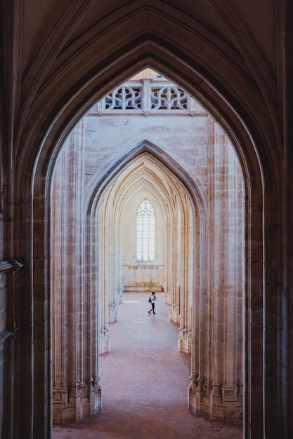 Vertical shot of the arch shaped hallways in an old building