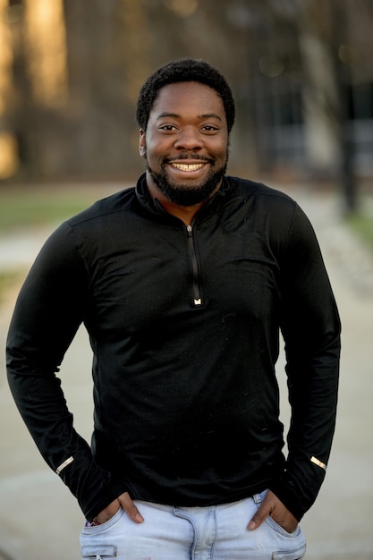 Free photo vertical shot of an attractive african american male smiling at the camera