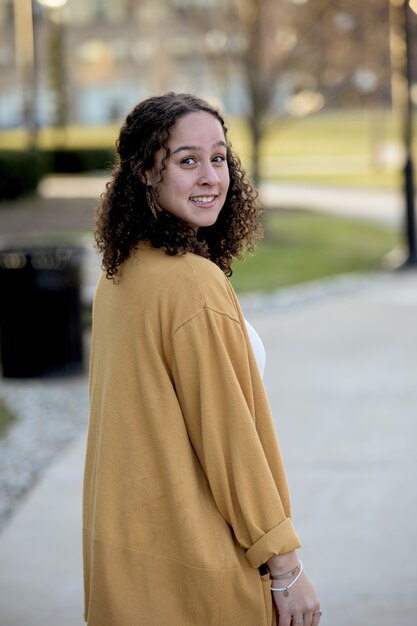 Vertical shot of an attractive white female smiling at the camera