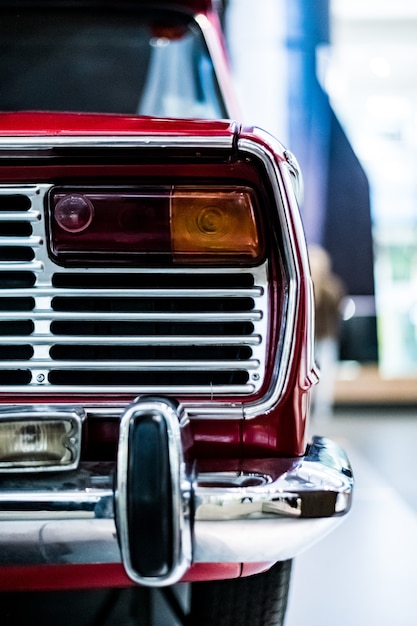 Free photo vertical shot of the back part of a vintage classic red car