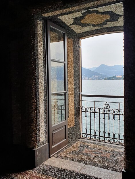 Vertical shot of a balcony with the view of the sea and hills