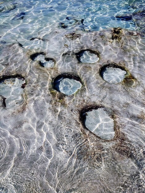 Vertical shot of the beach with blank spots on the surface in Formentera, Spain