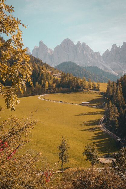 Vertical shot of a beautiful village in a hill surrounded by mountains