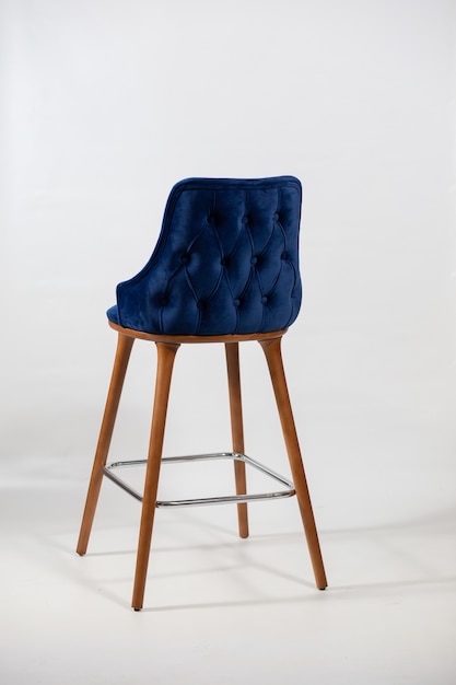 Vertical shot of a blue chair made up of wooden legs
