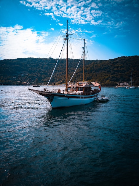 Vertical shot of a boat with a beautiful landscape