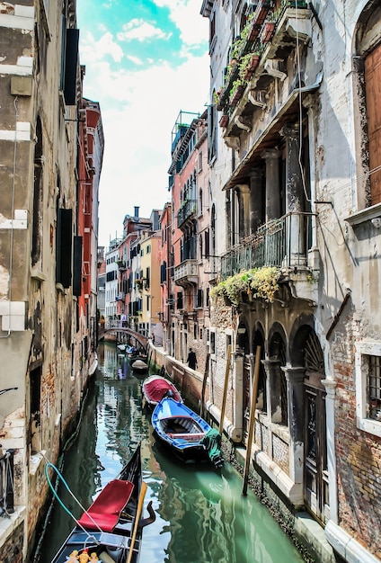 Vertical shot of the boats on the river going through the buildings and houses