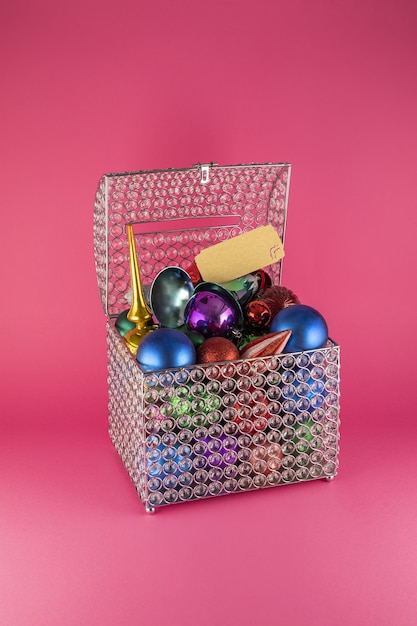 Vertical shot of a box full of colorful Christmas tree toys