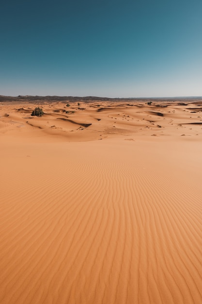 Vertical shot of the breathtaking desert under the blue sky captured in Morocco