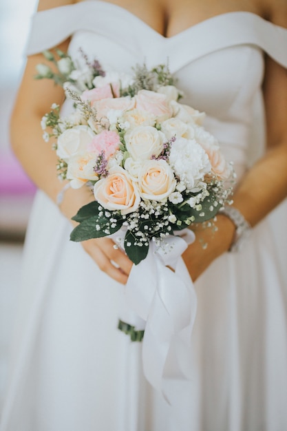 Vertical shot of a bride with a bouquet