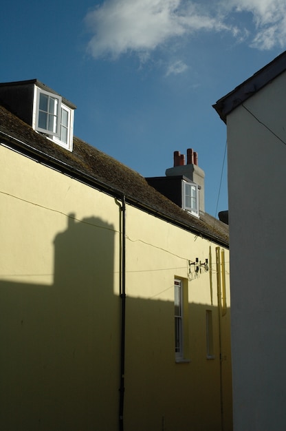 Vertical shot of a brown and light yellow building under a blue sky