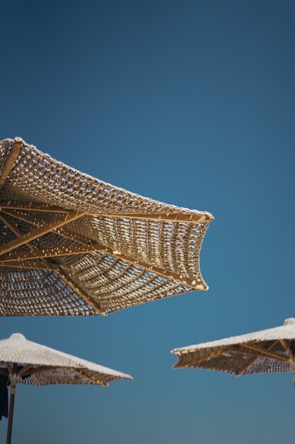 Vertical shot of brown wooden parasols