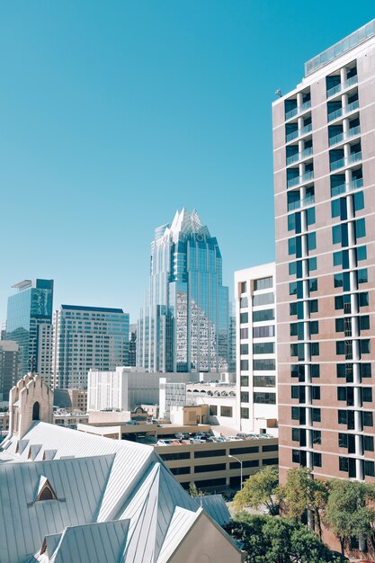 Vertical shot buildings in Downtown Austin and a tall glass building in Texas, USA