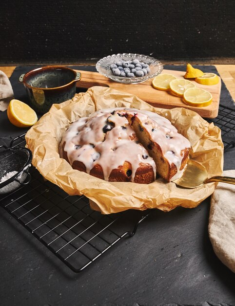 Vertical shot of a Cherry Cake with cream and ingredients on the side