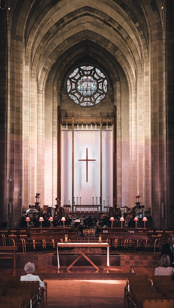 Vertical shot of a church hall with a beautiful interior during a religious ceremony