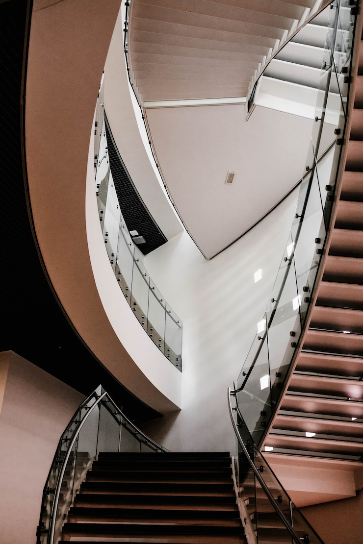 Free Photo vertical shot of concrete stairs inside a building with turned-on lights