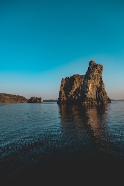 Vertical shot of a couple of big rocks in the sea