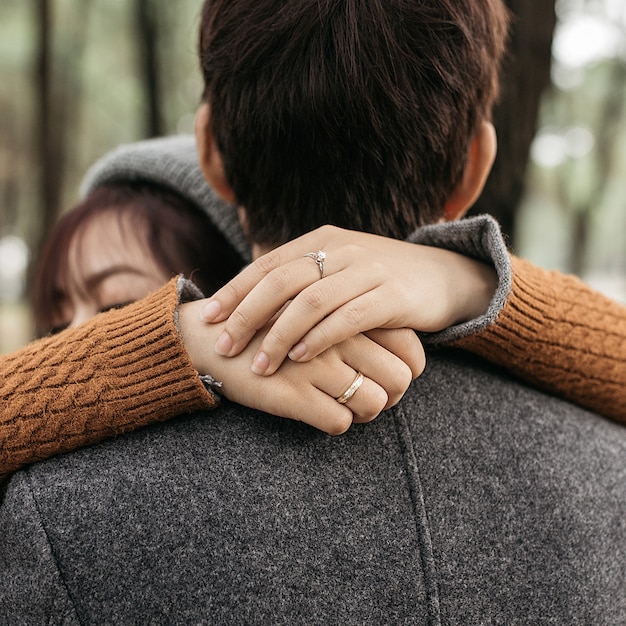 Vertical shot of a couple hugging each other in love