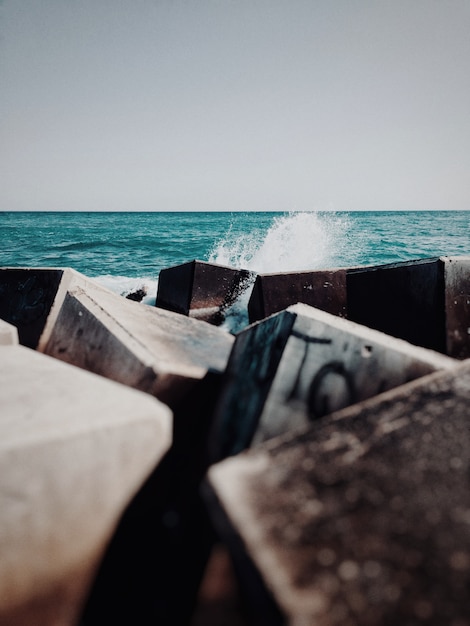 Vertical shot of cubical rubbles and trash in the body of water in the ocean