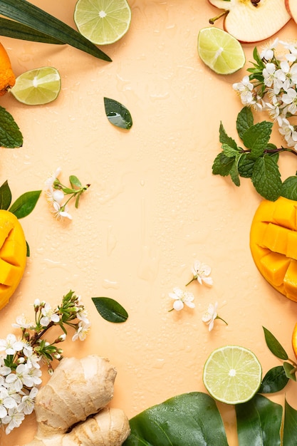 Vertical shot of cut fruits on a light orange distance