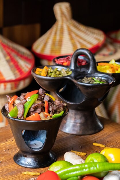 Vertical shot of delicious Ethiopian food with fresh vegetables on a wooden table