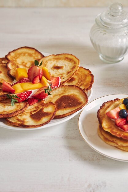 Vertical shot of delicious pancakes with fruits in the middle