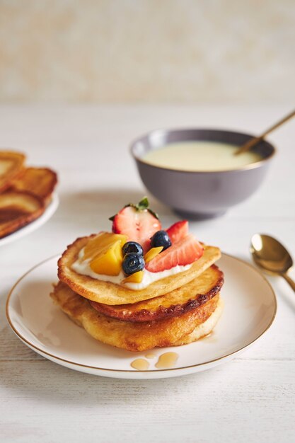 Vertical shot of delicious pancakes with fruits on the top