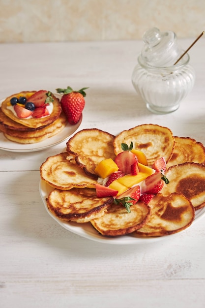 Vertical shot of delicious pancakes with fruits