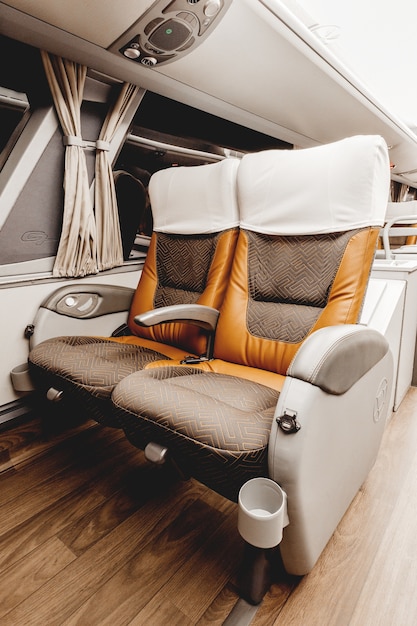 Vertical shot of an elegant car interior with leather seats and white curtains