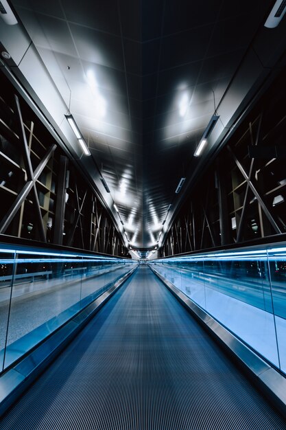 A vertical shot of an empty bridge at night time