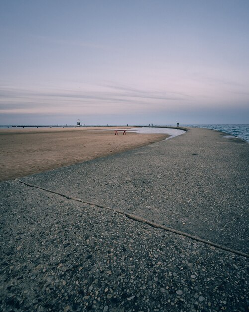 Vertical shot of an empty seashore and a clear blue sky