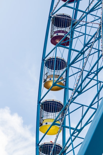 Vertical shot of ferries wheel with  cloudy sky in the background