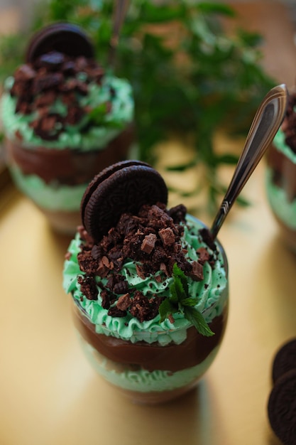 Vertical shot of a glass of chocolate mint parfait on a smooth surface