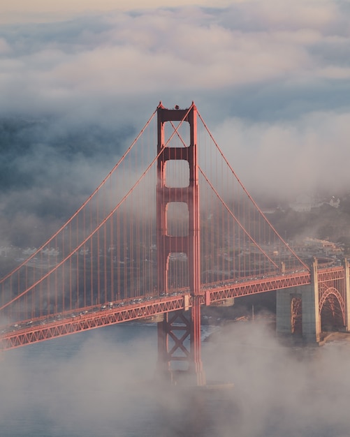 Vertical shot of the Golden Gate Bridge covered in the fog