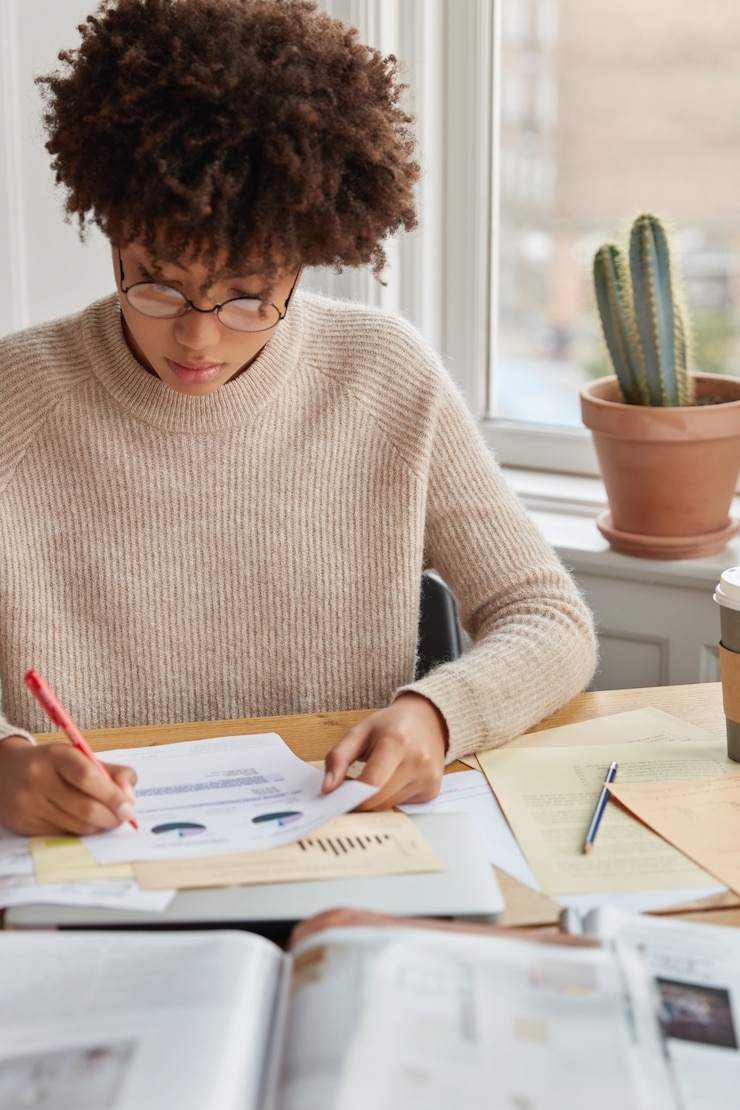 Free Photo vertical shot of hard working student with afro haircut