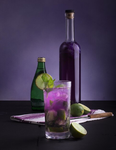 Vertical shot of healthy holiday mocktail with lime and bottles on the side