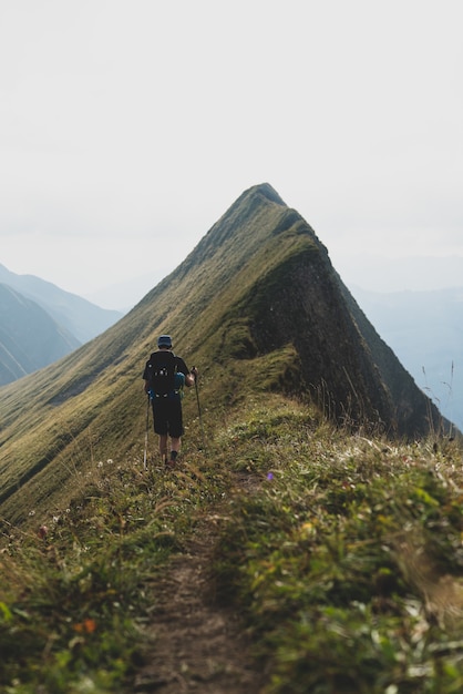 Vertical shot of a hiker in Hardergrat trail in Swiss alps