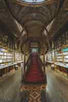 Free photo vertical shot of the interiors of lello centenary bookshop captured in oporto, portugal